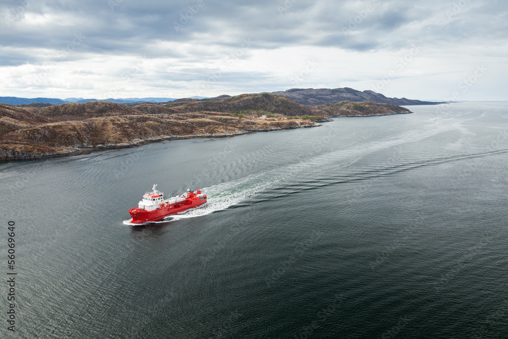 Fototapeta premium Small Norwegian red oil products tanker ship in the fjord