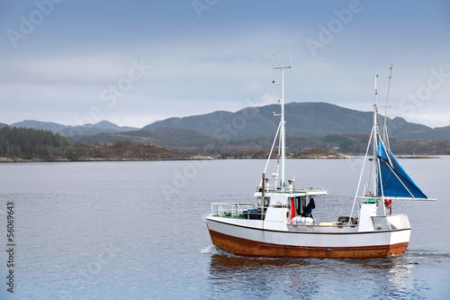 Small fishing boat in fjord of Norway © evannovostro