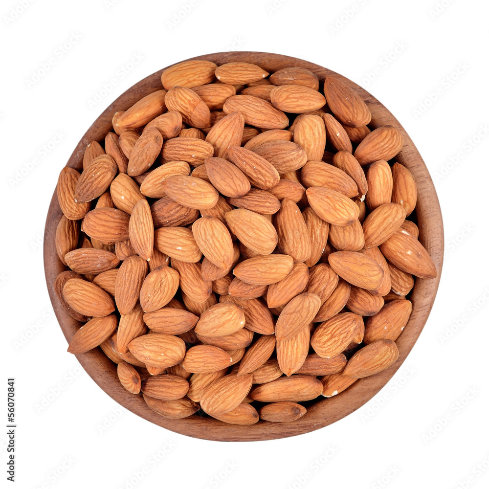 Peeled almonds in a wooden bowl on a white background Peeled almonds in a wooden bowl on a white background