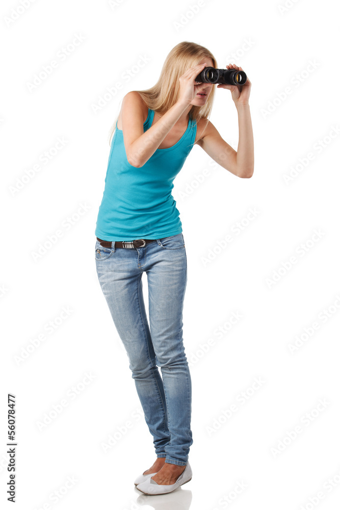 Full length blond woman looking through binoculars sideways Full length blond woman looking through binoculars sideways