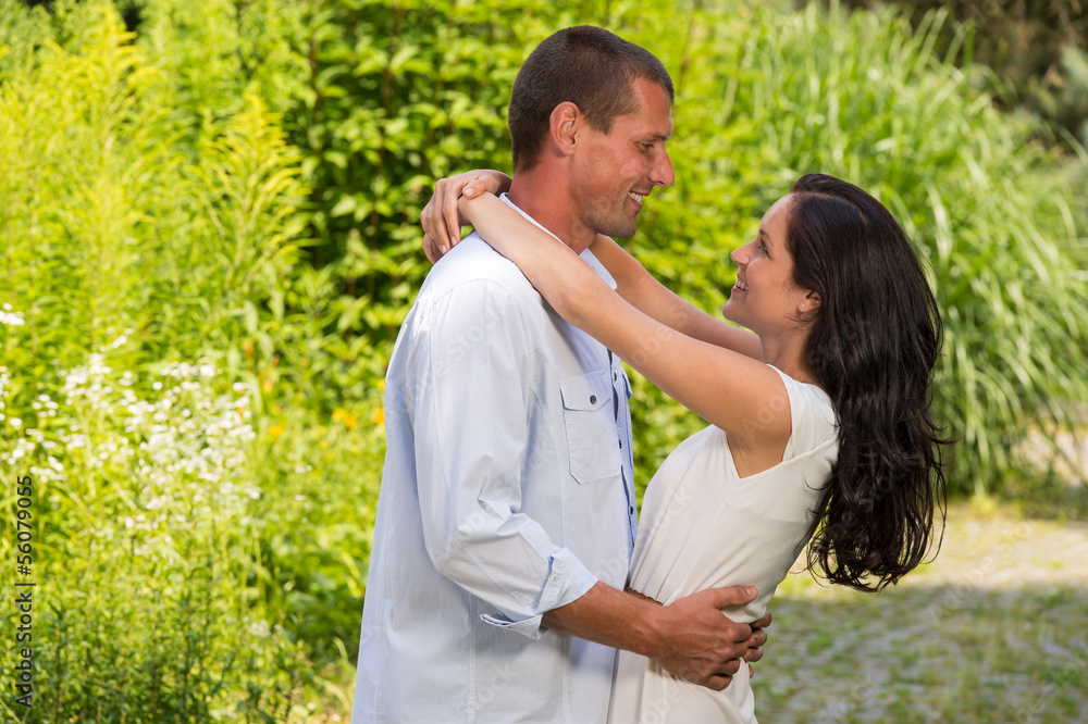 Playful Caucasian couple embracing outdoors Playful Caucasian couple embracing outdoors