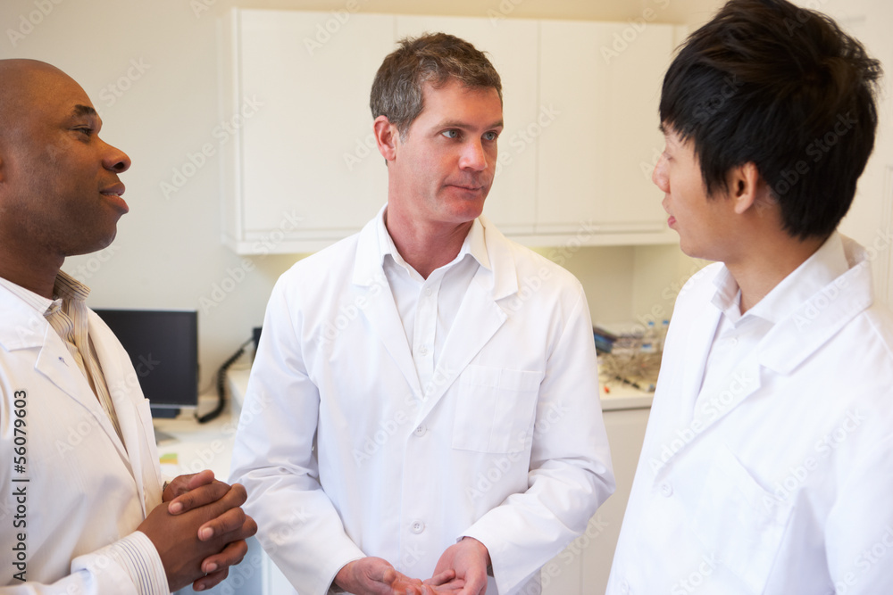 Obraz premium Three Doctors Having Discussion Using Digital Tablet