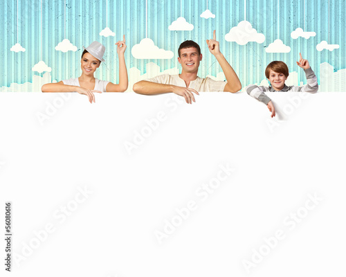 Happy young family with blank banner