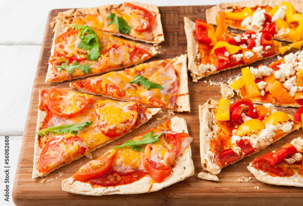 Backed flatbread with variety of toppings. Backed flatbread with variety of toppings.