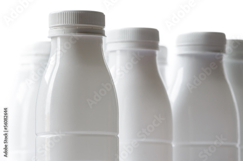 Group of white plastic milk bottle on white background photo