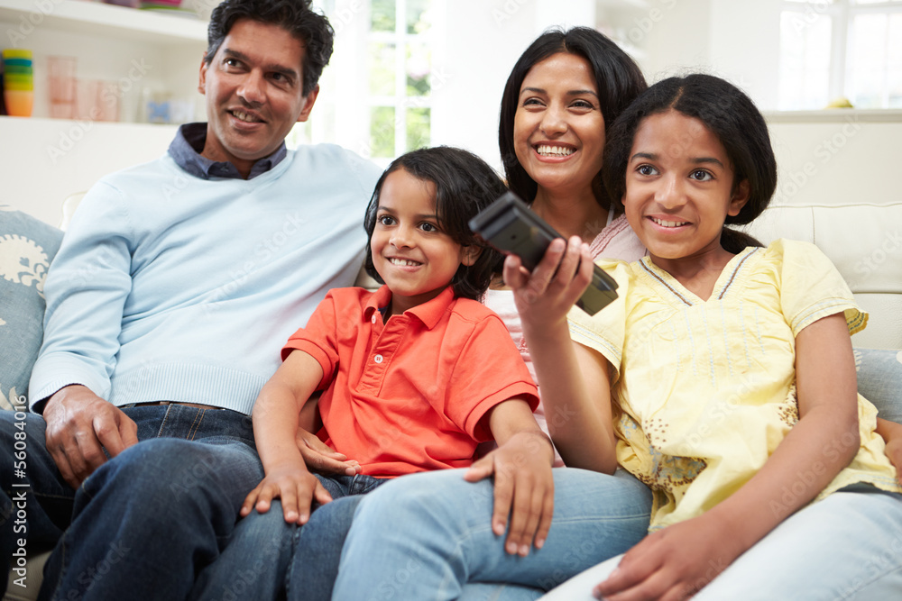 Indian Family Sitting On Sofa Watching TV Together Indian Family Sitting On Sofa Watching TV Together