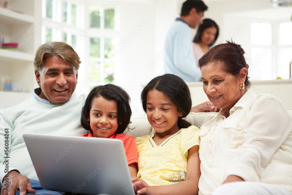 Indian Family With Laptop At Home Indian Family With Laptop At Home