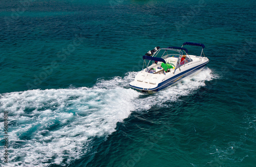 Powerboat on blue open water © xbrchx