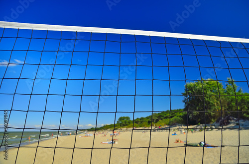 Net for beach volleyball on the gold beach
