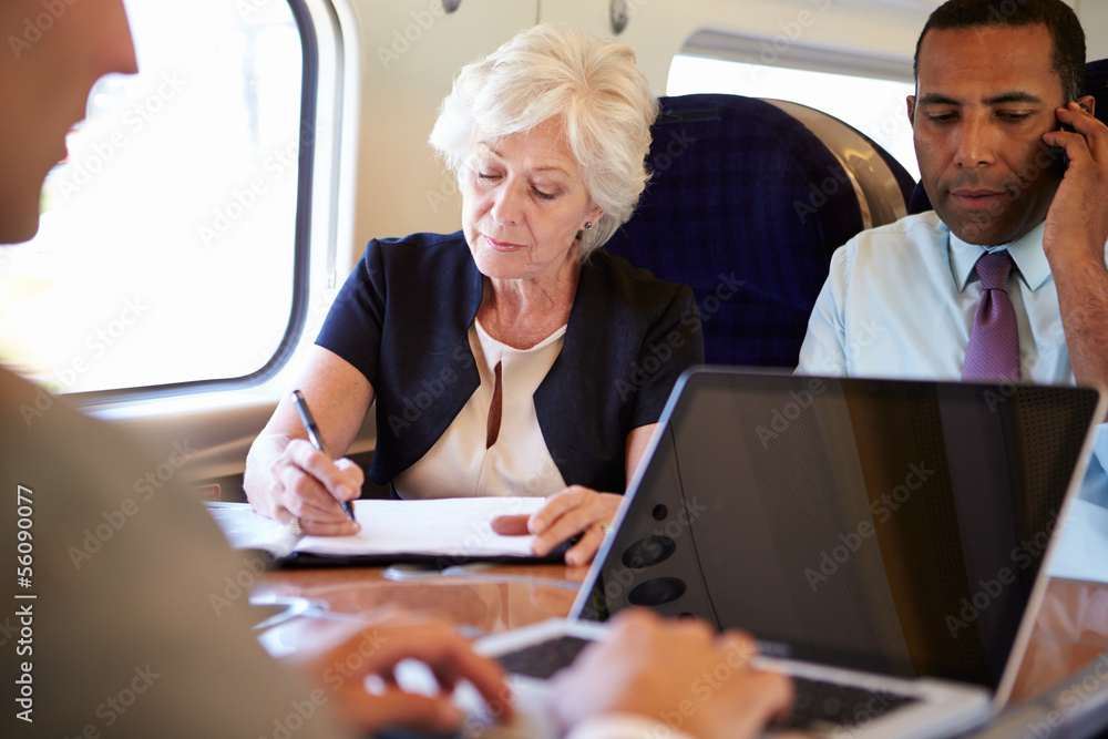 Businesspeople On Train Using Digital Devices Businesspeople On Train Using Digital Devices