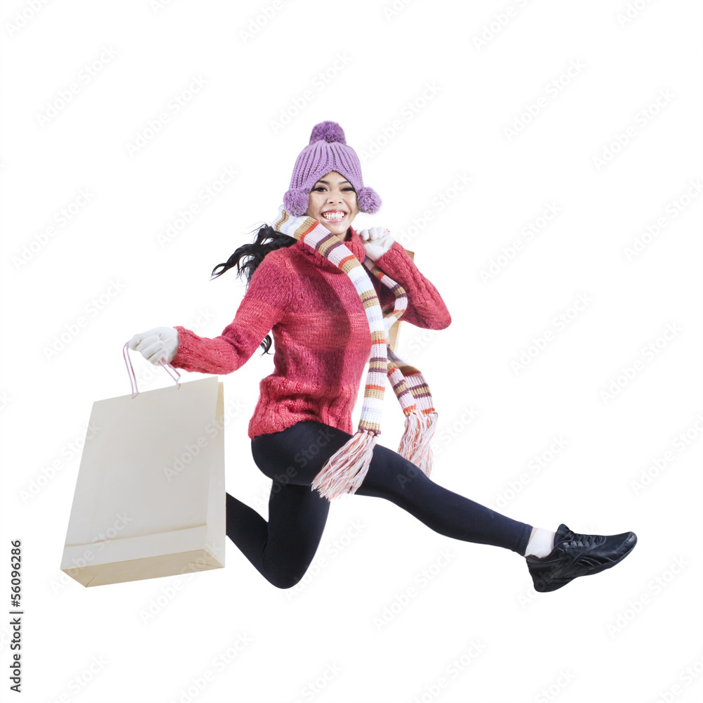 Happy woman with shopping bags jumping Happy woman with shopping bags jumping