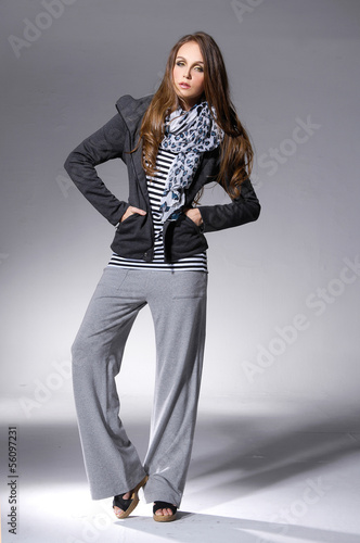 full length young woman in a scarf, over light background.