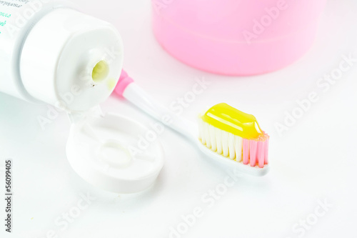 Toothbrush and toothpaste on white background