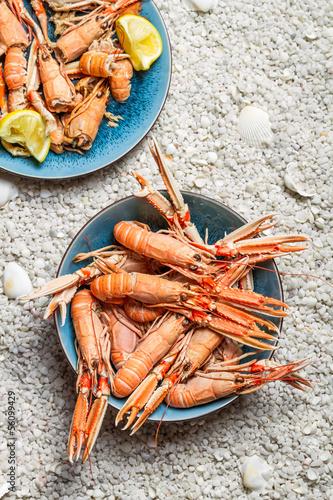 Scampi served with lemon on the beach photo