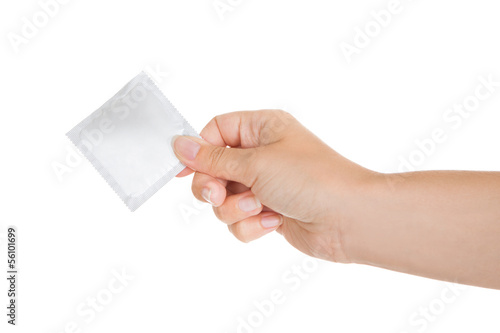 Close-up of hand holding condom packet