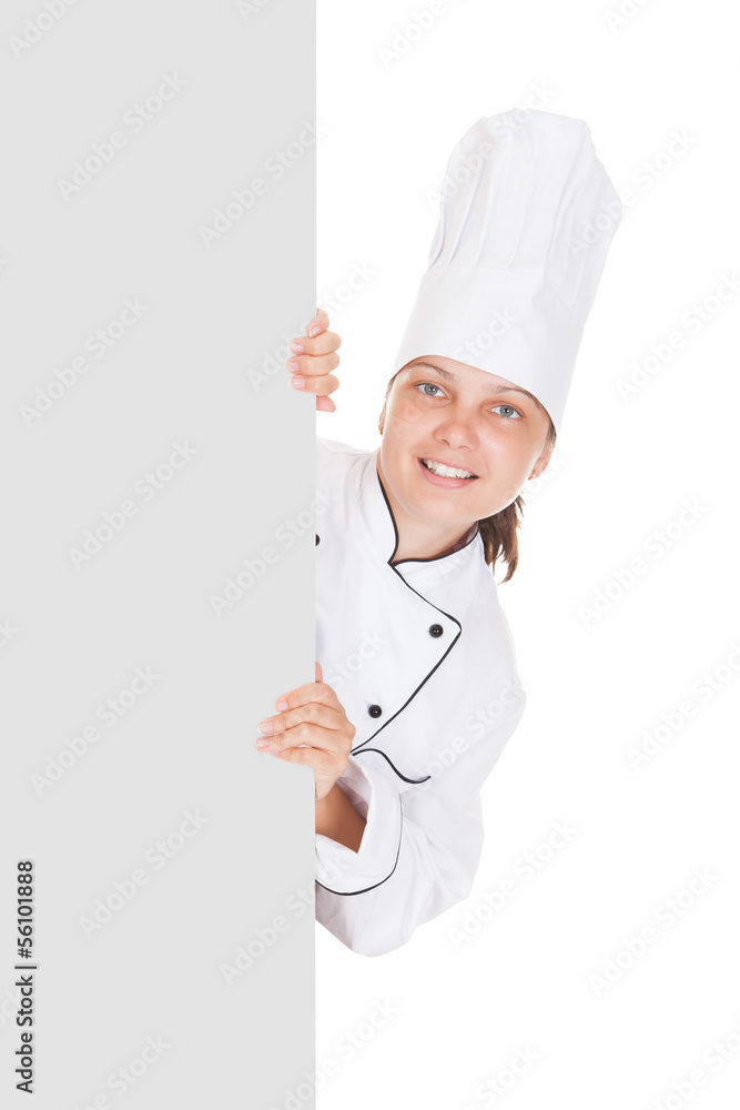 Female chef pointing on blank placard Female chef pointing on blank placard