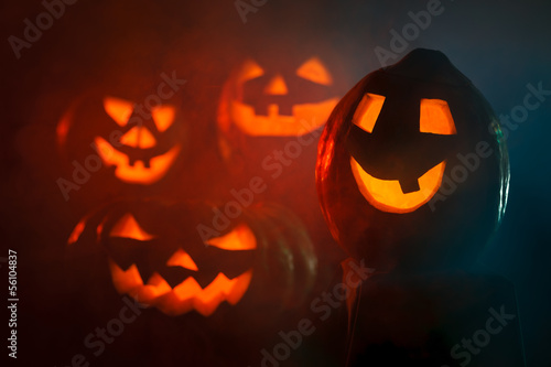 Four scary Halloween Pumpkin looking through the smoke