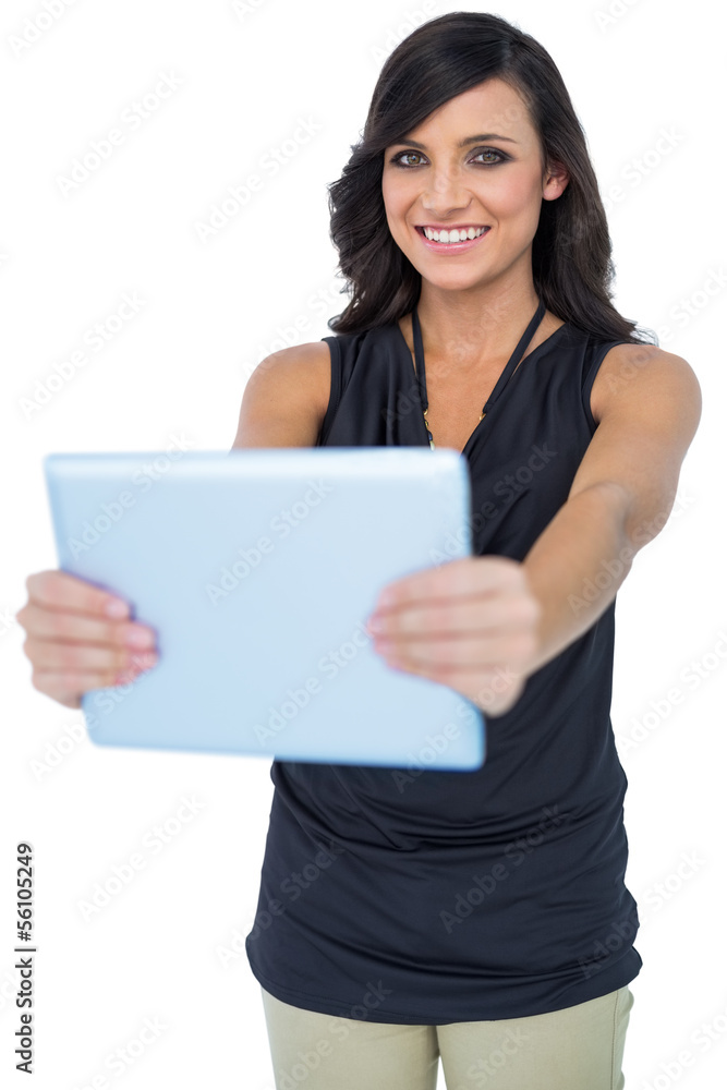 Smiling elegant dark haired model holding her tablet Smiling elegant dark haired model holding her tablet