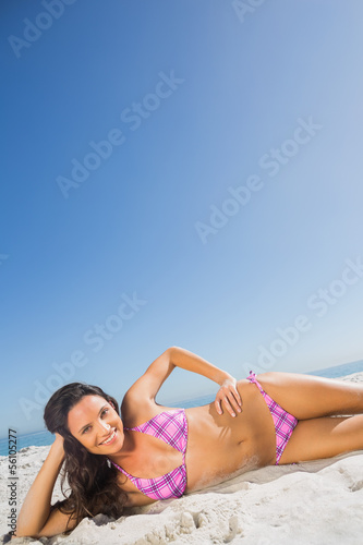 Cheerful tanned brunette posing © WavebreakMediaMicro