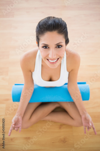 Pretty woman with her exercise mat sitting in lotus pose © lightwavemedia