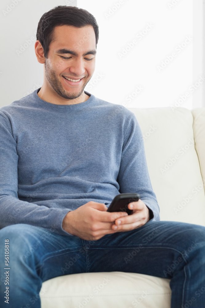 Handsome casual man text messaging Handsome casual man text messaging