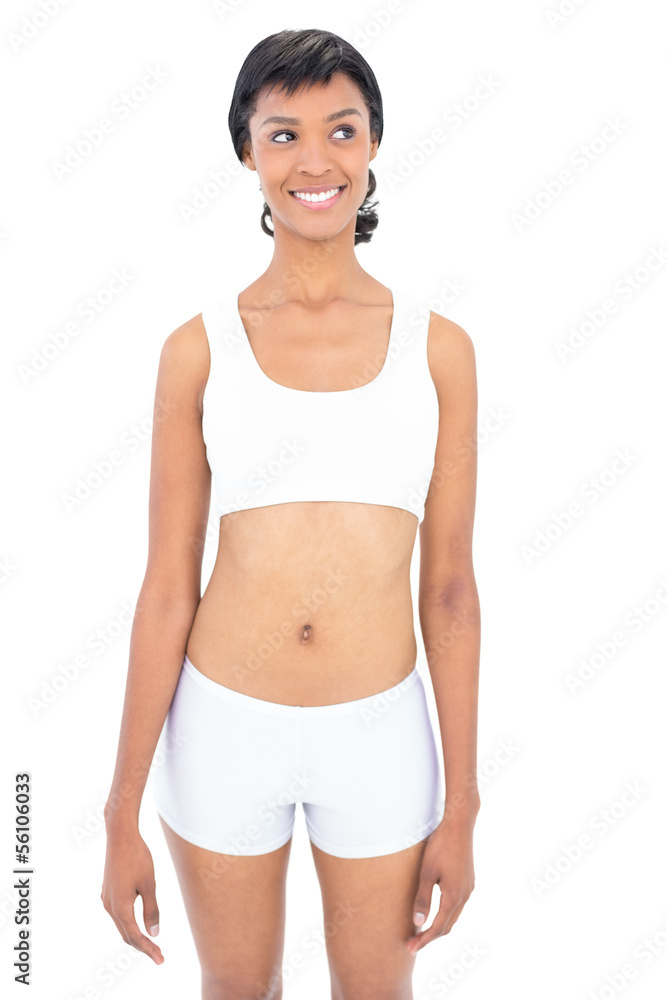 Smiling fit woman posing looking away Smiling fit woman posing looking away