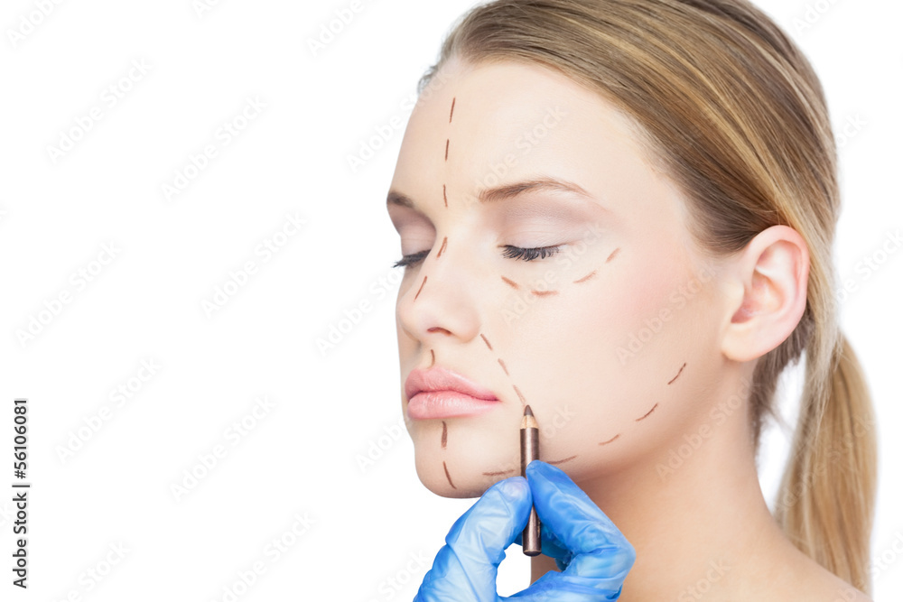Surgeon drawing dotted lines on cute patient Surgeon drawing dotted lines on cute patient