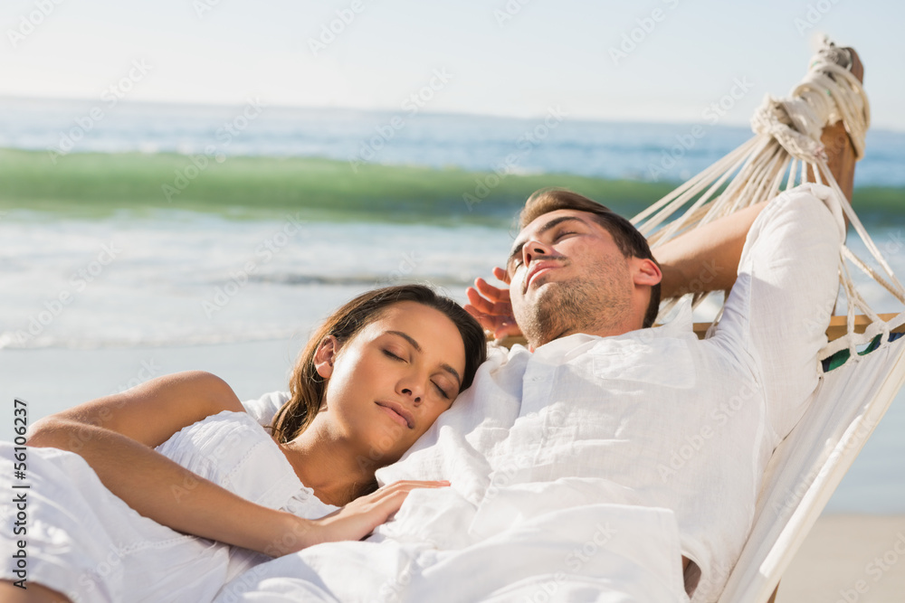 Peaceful couple napping in a hammock Peaceful couple napping in a hammock