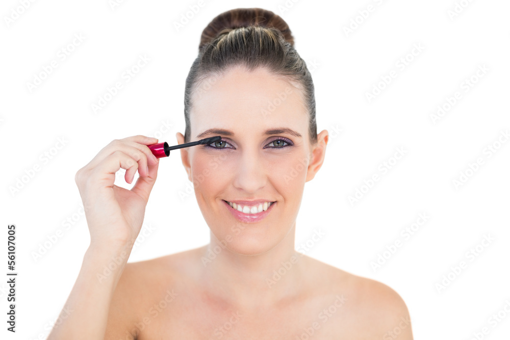 Young woman applying mascara Young woman applying mascara