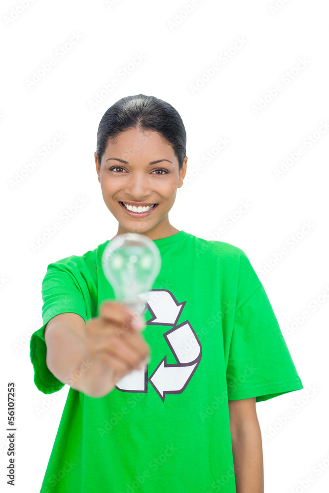 Smiling model wearing recycling tshirt holding light bulb Smiling model wearing recycling tshirt holding light bulb