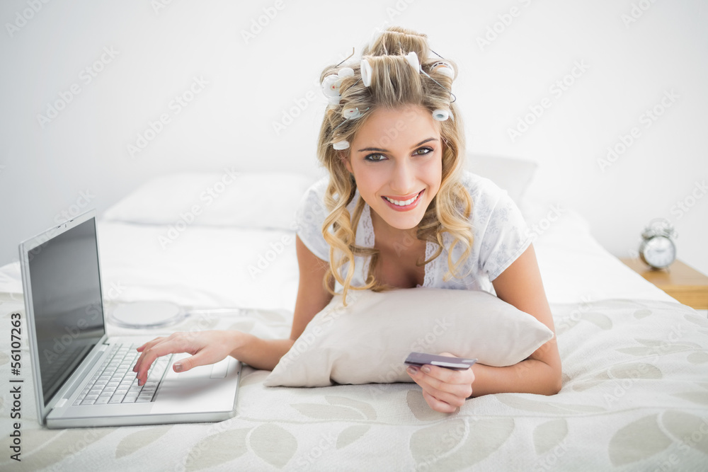 Cheerful natural blonde shopping online using laptop Cheerful natural blonde shopping online using laptop