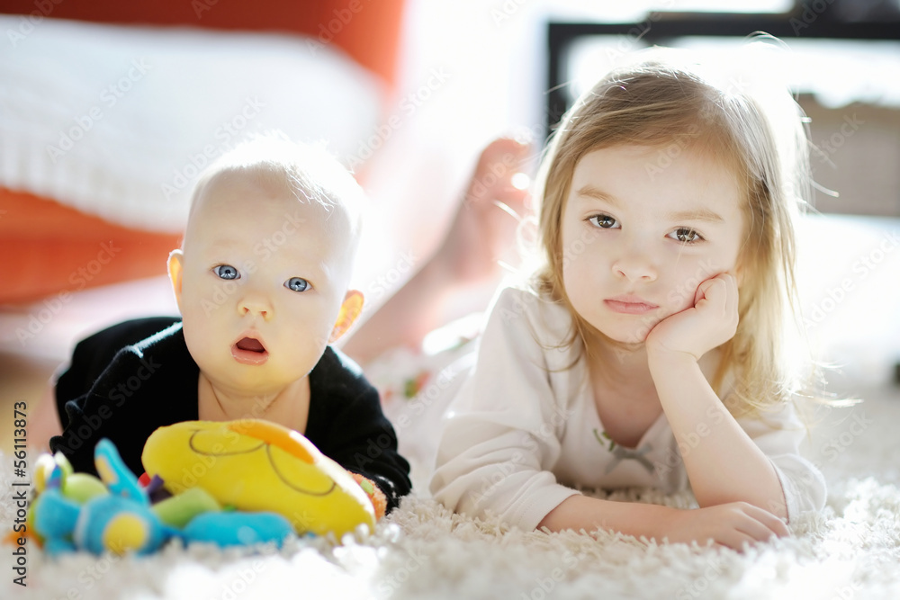 Obraz premium Two sibling sisters at home