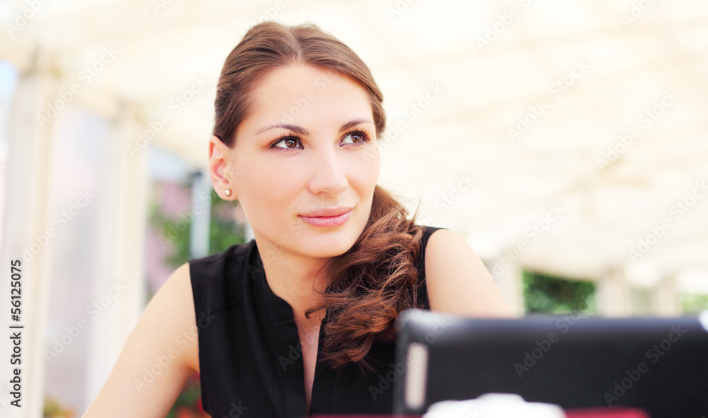 Image of pretty young woman in cafe