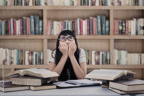 Asian female student worry at library photo