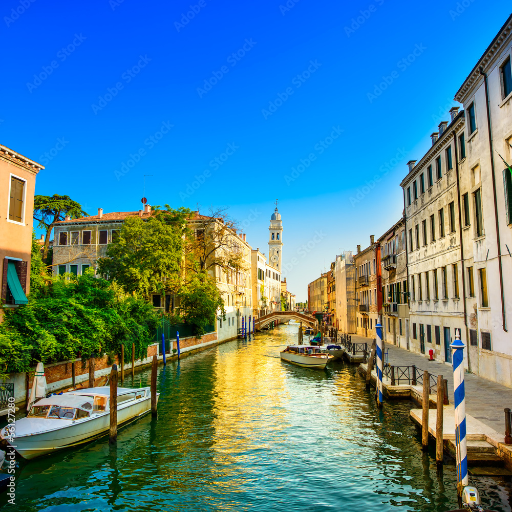 Venice sunset in water canal and church on background. Italy