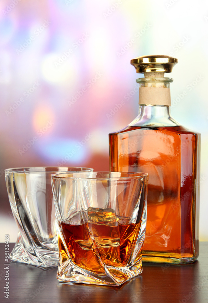 Glass of whiskey with bottle, on dark background Glass of whiskey with bottle, on dark background