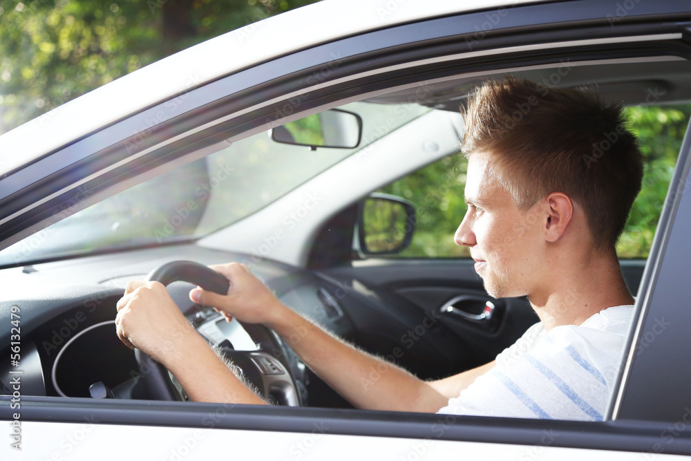 Young man in his new car Young man in his new car