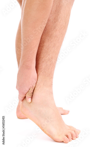 Young man with leg pain, isolated on white © Africa Studio