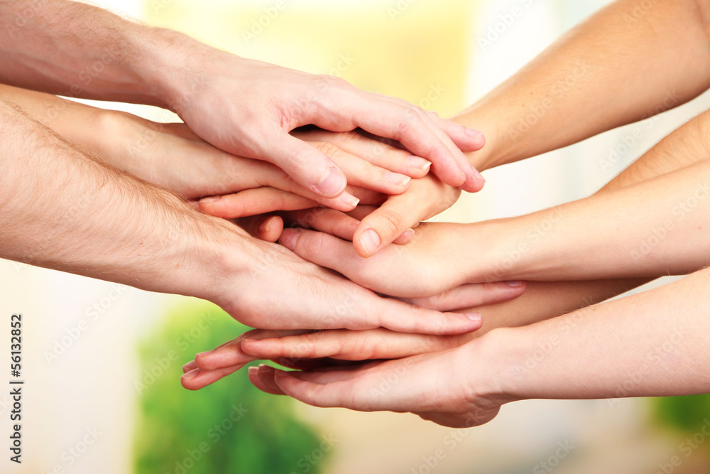 United hands on bright background. Conceptual photo of teamwork United hands on bright background. Conceptual photo of teamwork