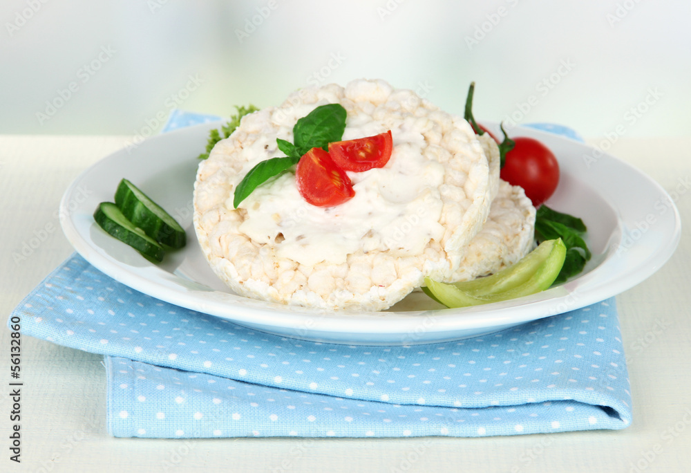 Tasty crispbreads with vegetables on white table