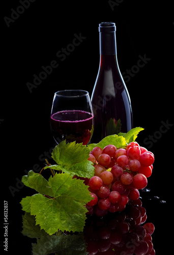 Red wine bottle, grapes and full glass