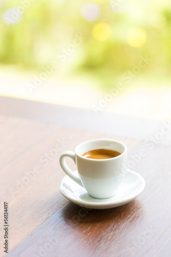 close up a cup of coffee on wooden table