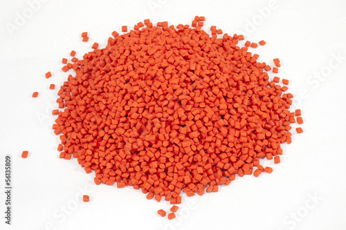 Obraz na płótnie orange plastic polymer granules on white background