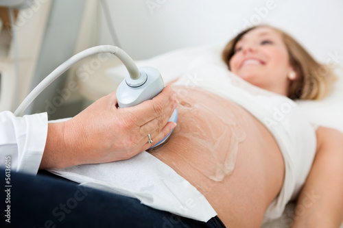 Female Doctor Scanning Pregnant Woman's Belly