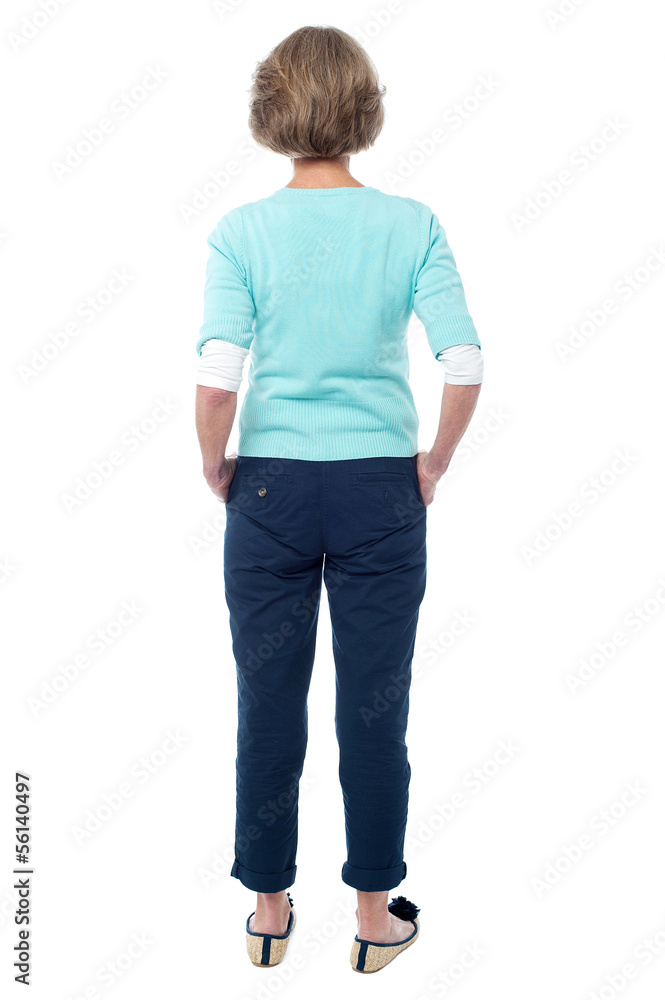 Back pose of an old lady facing the wall Back pose of an old lady facing the wall
