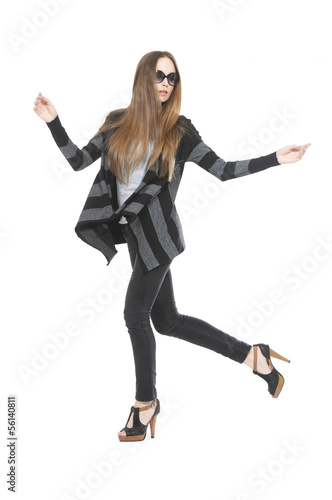 Full length The young long-haired girl jumping in studio