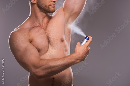 Man shaving. Handsome young shirtless man shaving with electric