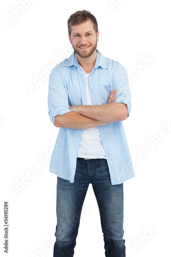 Smiling man crossing arms