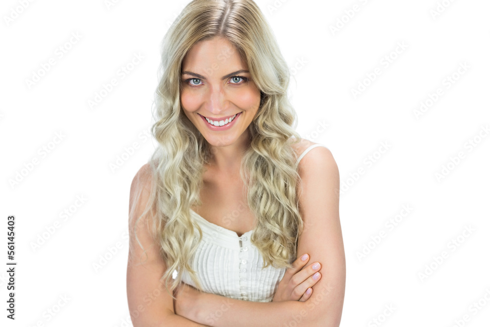 Cheerful seductive model in white dress posing crossing arms Cheerful seductive model in white dress posing crossing arms