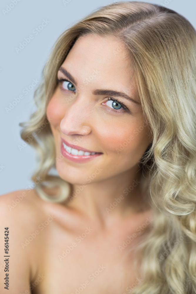 Smiling natural blonde posing while looking at camera Smiling natural blonde posing while looking at camera